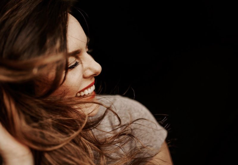Kentucky photographer, Dani Ford, smiles and flips hair with ease for a self-portrait.