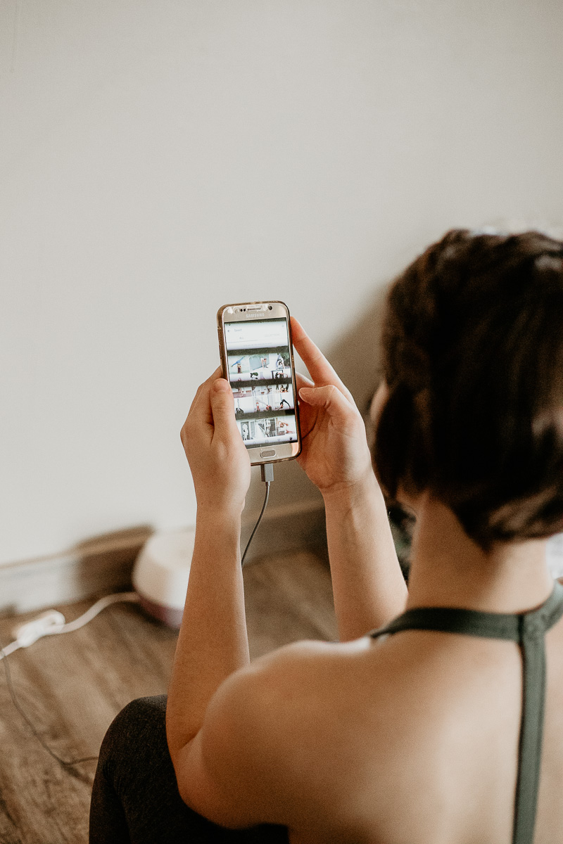 A photograph looking over a girl's shoulder as she uses social media.