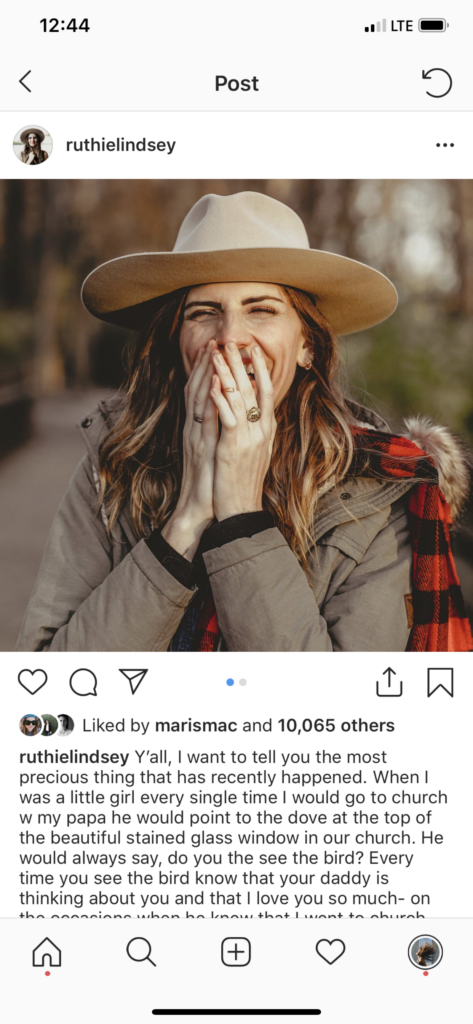 Screenshot of Ruthie on Instagram, looking at the camera with her hands covering her laughing smile.