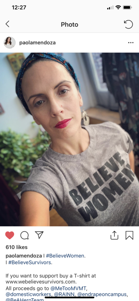 A screenshot of Paola Mendoza on her Instagram account taking a selfie and wearing a t-shirt that says, "Believe Women".